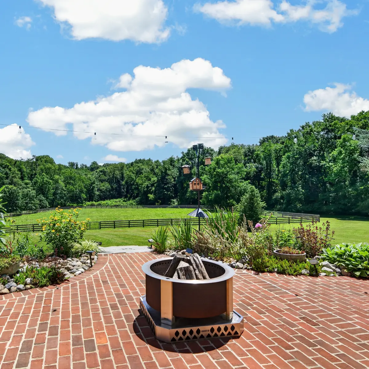 Brick patio fire pit and bird garden overlooking the paddocks