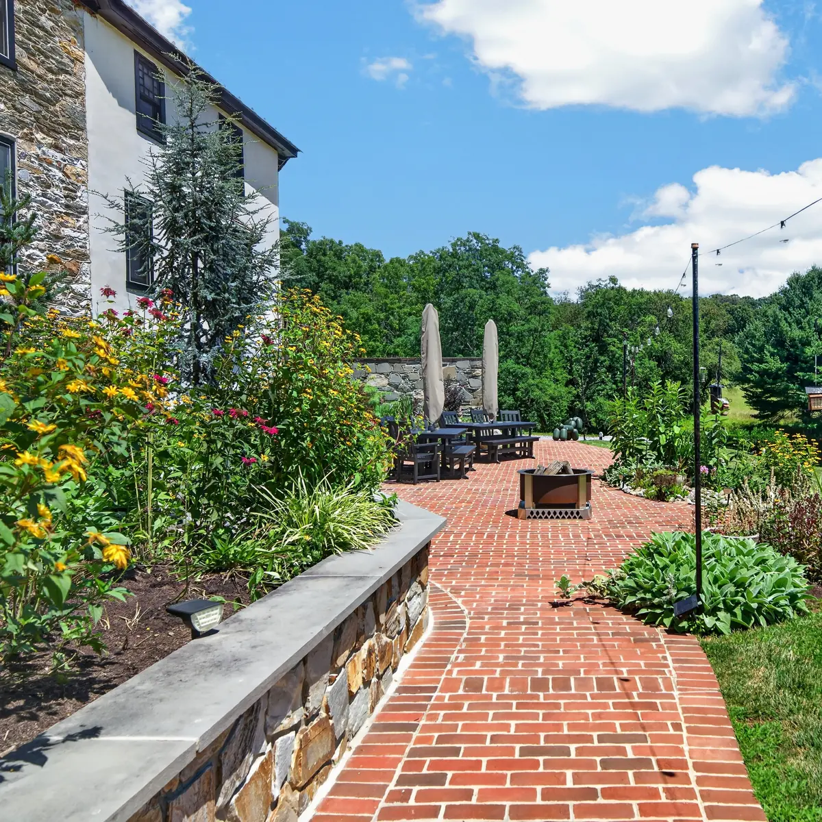Brick patio path along the house toward the dining terrace
